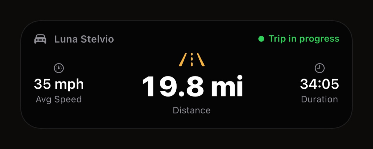 the WrenchTime trip Live Activity as it appears on the Lock Screen: vehicle, trip in progress, average speed, distance, duration